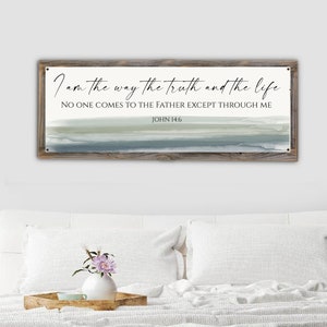 May include: A wood framed sign with a white background and a blue and green watercolor design. The sign features the text "I am the way the truth and the life. No one comes to the Father except through me. John 14:6"