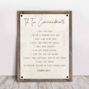May include: A rustic wooden sign with the text "The Ten Commandments" and a list of the commandments, including "Put God First", "Praise & Worship Only Him", and "Keep Gods Name Holy". The sign also includes the text "Exodus 201-17".
