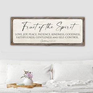 May include: A rectangular wooden sign with the text "Fruit of the Spirit" in elegant script. Below, a list of virtues: Love, Joy, Peace, Patience, Kindness, Goodness, Faithfulness, Gentleness, and Self-Control. The scripture reference Galatians 5:22-23 is at the bottom.