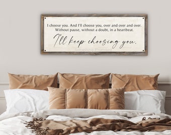 May include: A rustic wooden sign with a white background and black text. The sign reads "I choose you. And I'll choose you, over and over and over. Without pause, without a doubt, in a heartbeat. I'll keep choosing you. Something Promised."