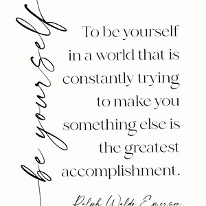 May include: A minimalist print on a cream background features the quote "To be yourself in a world that is constantly trying to make you something else is the greatest accomplishment." by Ralph Waldo Emerson. The words "Be yourself" are written in cursive.