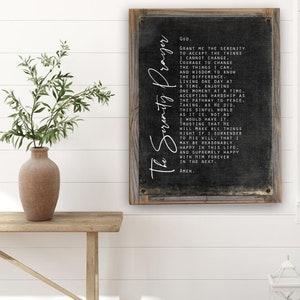 May include: A black and white framed sign with a black background and white text. The text is the Serenity Prayer, a well-known prayer for peace and acceptance. The sign is a great addition to any home decor.