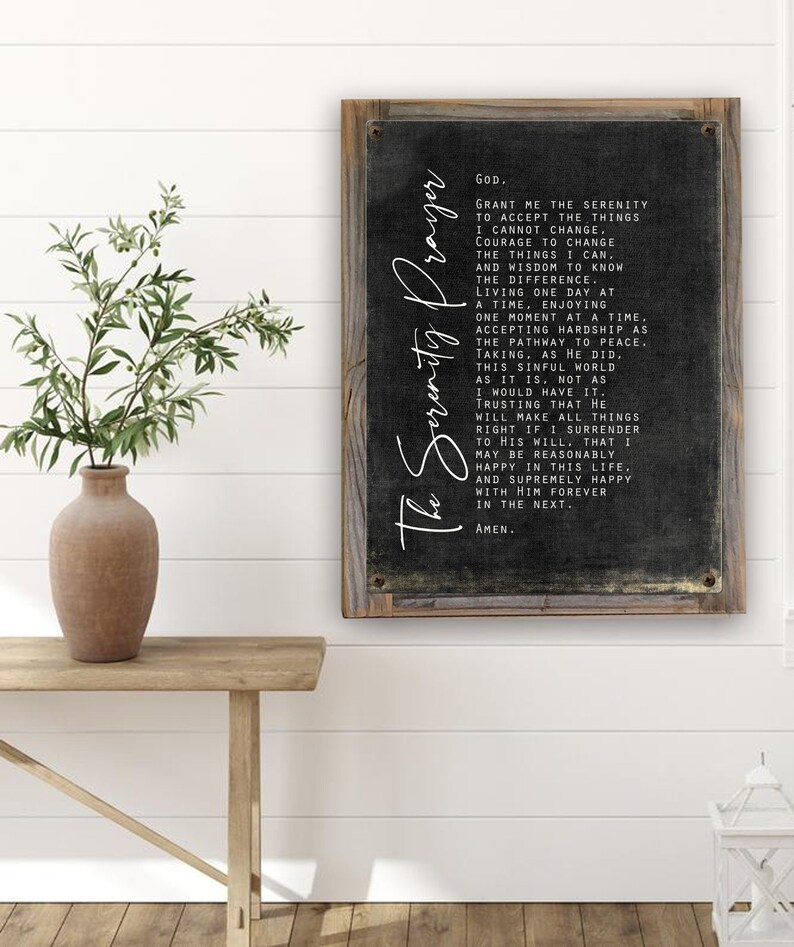 May include: A black and white framed sign with a black background and white text. The text is the Serenity Prayer, a well-known prayer for peace and acceptance. The sign is a great addition to any home decor.