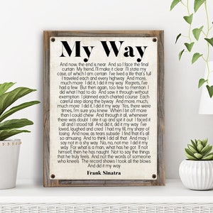 May include: A vintage-style wood sign with a white background and black text. The sign features the lyrics to the song "My Way" by Frank Sinatra. The lyrics are printed in a bold, sans-serif font.