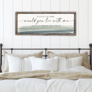 May include: A wooden sign with a gray and blue watercolor background. The sign reads "IF I JUST LAY HERE would you lie with me AND JUST FORGET THE WORLD?"