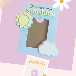 May include: A light blue picture frame with a yellow sun, a white cloud, and the text "You are my Sunshine". The frame is a digital file.