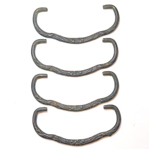May include: A set of four matching metal drawer pulls with a dark, weathered finish. Each pull features a curved, arching shape with a textured, embossed floral pattern along the center and smooth, rounded ends for mounting to furniture.