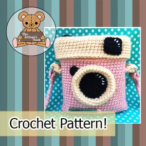 May include: Crochet pattern for a pink and cream camera-shaped bag with a black lens and a strap. The bag is on a turquoise background with white polka dots. The text "Crochet Pattern!" is at the bottom of the image.