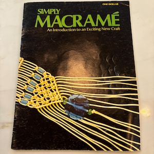 May include: A vintage book titled "Simply Macrame: An Introduction to an Exciting New Craft" with a cover image of a macrame piece with a blue bead.