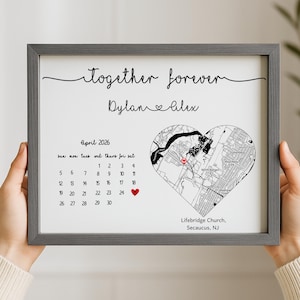 May include: A framed print with the words "together forever" and the names "Dylan & Alex" in script. It features a calendar for April 2026, a heart-shaped map, and the location "Lifebridge Church, Secaucus, NJ."