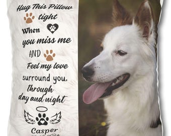 May include: White memorial pillow with a black paw print and a halo. The pillow has a white dog with brown ears on the right side of the pillow. The text on the pillow reads "Hug This Pillow tight When you miss me AND Feel my love surround you. through day and night Casper 08.23.2024".