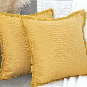 Copricuscini autunnali giallo senape con frange sul bordo, federe decorative testurizzate con volant, copricuscini moderni per l'arredamento del portico