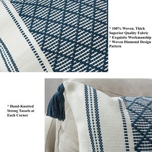 May include: Two throw pillows with a white background and blue diamond pattern. The pillows have hand-knotted tassels at each corner. The text on the image reads: "100% Woven, Thick Superior Quality Fabric, Exquisite Workmanship, Woven Diamond Design Pattern, Hand-Knotted Strong Tassels at Each Corner."