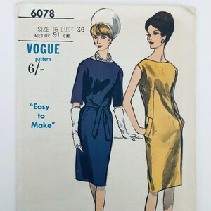 May include: A vintage Vogue sewing pattern envelope numbered 6078, featuring illustrations of two dresses. One is a navy blue dress with a belt and white gloves, the other is a sleeveless yellow dress. Text includes Size 16, Bust 36, 91 cm, and Easy to Make.
