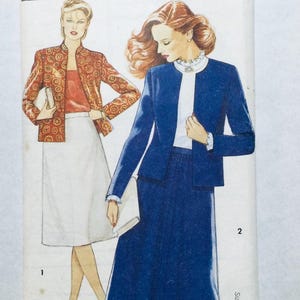 May include: A sewing pattern featuring two women's outfits. The first outfit is a red and gold patterned jacket with a red top and a white skirt. The second outfit is a blue jacket with a white blouse and a blue skirt. The pattern is labelled "1" and "2".
