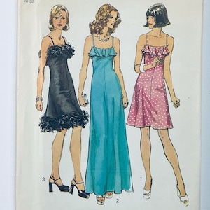 May include: A vintage sewing pattern showcasing three women in various dress styles. The first dress is black with a ruffled hem, the second is a turquoise maxi dress, and the third is a pink polka dot dress.