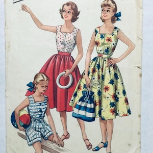 May include: Vintage sewing pattern featuring three women and a girl in summer dresses and shorts. The dresses are in red, yellow, and white with floral and polka dot patterns. The girl is holding a beach ball. The pattern is on aged paper.