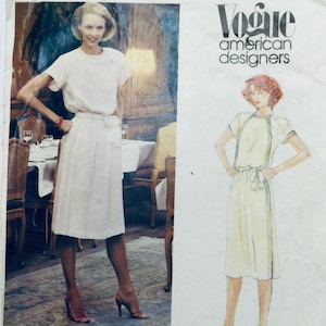 May include: A vintage Vogue pattern for a dress with a simple, elegant design. The pattern features a white dress with a tie belt and short sleeves. The pattern is from the American Designers collection.