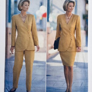 May include: A mustard-coloured women's suit featuring a wrap-style blazer with matching trousers. The blazer has gold buttons and a V-neck. The second image shows the same blazer with a matching skirt. The model is wearing a pearl necklace.