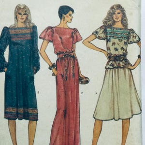 May include: Three different dress patterns featuring a long-sleeved dress with a high neckline, a long-sleeved jumpsuit with a wide leg, and a short-sleeved top with a skirt. The dresses are in shades of blue, red, and white.