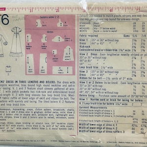 Cute dress with high round neckline and either short very puffy sleeves or set in sleeves with puffy gathers at wrist. Gathered high waist and optional gathered lower skirt band. Patch pockets, trim and lined bolero.