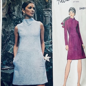 May include: Vintage sewing pattern for a dress with a high neck and pockets. The pattern is for size 2451 and is from the brand "Talco of Italy".
