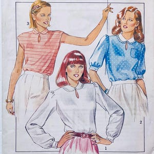 May include: Illustration of three women wearing different blouses. One blouse is white with long sleeves, another is light blue with white polka dots, and the third is pink and white striped. All blouses have a keyhole neckline and are paired with white skirts.