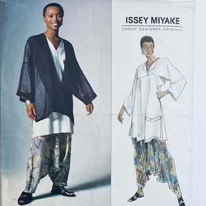 May include: A sewing pattern envelope for an Issey Miyake Vogue Designer Original featuring a black jacket, a white tunic, and patterned trousers. The cover displays a photograph of the garments alongside a technical line drawing illustration.