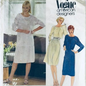 May include: A vintage Vogue pattern for a dress and skirt. The pattern features three women wearing different styles of dresses. The text on the pattern reads "Vogue American Designers".