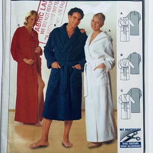 May include: Image of a pattern for bathrobes. Three people model different coloured robes: red, navy blue, and white. The pattern includes diagrams of the robe designs. The text "FABRIC LANE" is visible.