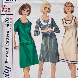 May include: Vintage Simplicity printed sewing pattern with three dress designs. The pattern includes a green dress with a square neckline, a striped dress with a white collar, and a beige dress with black trim. Size 16, bust 91 cm.