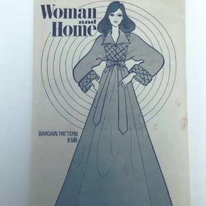 May include: A vintage sewing pattern envelope titled Woman and Home featuring a line drawing of a floor-length gown with long sleeves, a collared bodice, and a tie waist. The pattern is labelled Bargain Pattern B 586 and displays a circular graphic design behind the illustrated figure in shades of blue and cream.