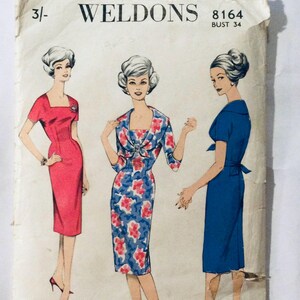 May include: Vintage sewing pattern for a dress with a square neckline and short sleeves. The pattern is for a bust size of 34 and is from the brand Weldons. The pattern shows three different styles of the dress, one in red, one in blue, and one in a floral print.