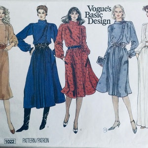 May include: A vintage sewing pattern for four different dresses. The pattern is called "Vogue's Basic Design" and the pattern number is 1022. The dresses are shown in brown, blue, red, and white.