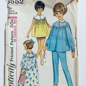 May include: Vintage sewing pattern for a girl's nightgown and pajamas. The pattern is for size 8, with a 26 inch bust. The pattern is printed on a white background with a blue and yellow color scheme.