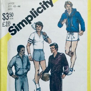 May include: A Simplicity sewing pattern for men's clothing. The pattern includes three different designs: a blue jacket with white shorts, a white shirt with blue shorts, and a brown shirt with black trousers. The pattern is for sizes 42-44.