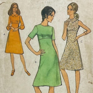 May include: Vintage sewing pattern featuring three dress designs. The dresses are illustrated in shades of orange, green, and a floral print. Each dress has a unique neckline and sleeve style, showcasing a retro fashion aesthetic.