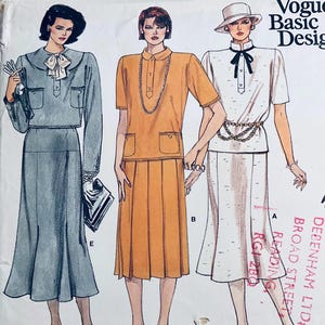 May include: Vintage Vogue Basic Design sewing pattern showing three women's outfits. The designs include a skirt suit, a collared top with a pleated skirt, and a white top with a skirt. The outfits are in shades of grey, orange, and white.