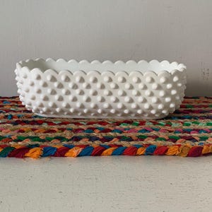 May include: A set of three ceramic mugs with a speckled, matte finish. The mugs are in shades of cream, light gray, and dark gray. Each mug has a simple, minimalist design, perfect for coffee or tea.