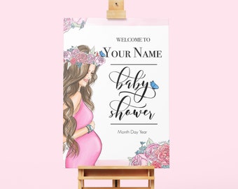May include: A white sign with a pink floral border and a drawing of a woman in a pink dress holding her belly. The sign says "Welcome to YOUR NAME baby shower Month Day Year".