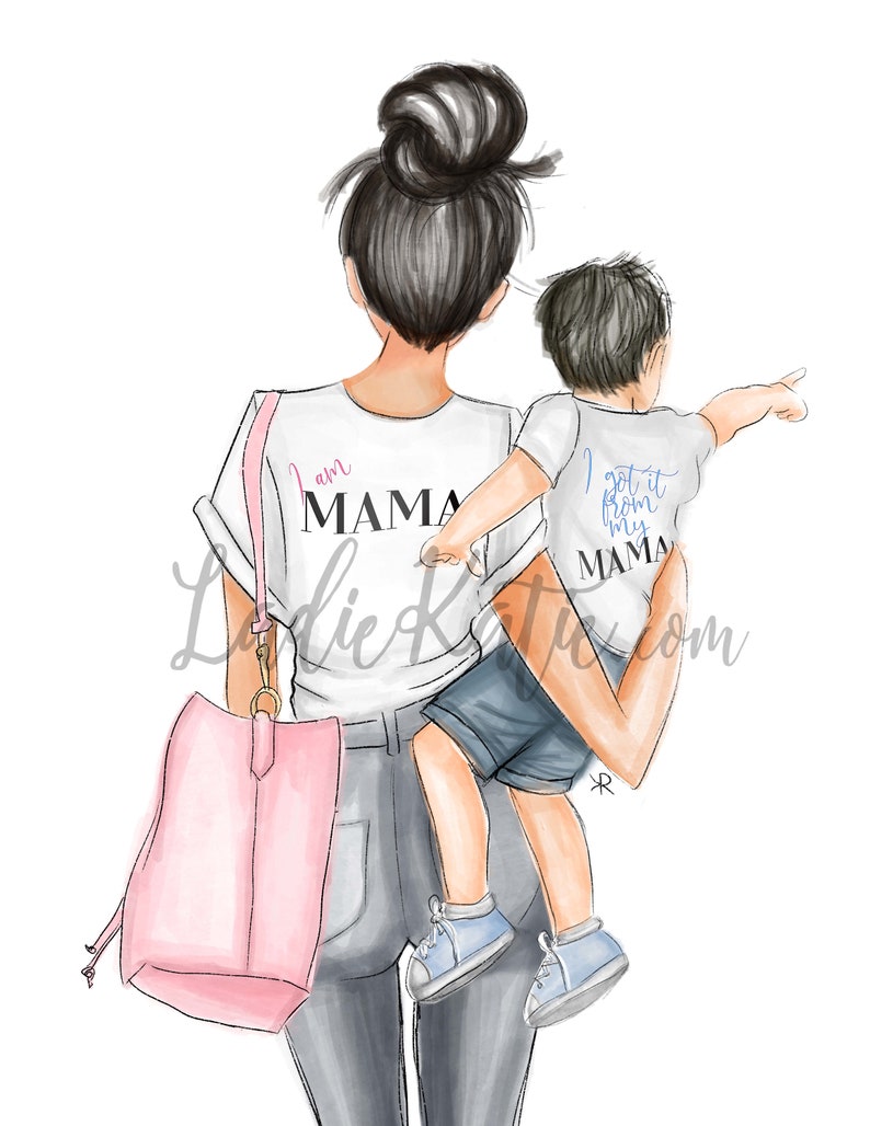 May include: A woman wearing a white t-shirt with the text "I am Mama" and a pair of jeans is carrying a young boy on her hip. The boy is wearing a white t-shirt with the text "I got it from my Mama". The woman is carrying a pink tote bag.