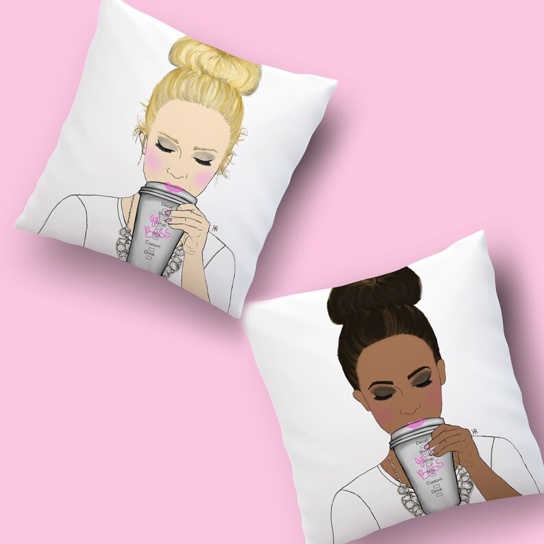 May include: Two white throw pillows with illustrations of women drinking coffee. The text on the coffee cups says "Girl Boss" in pink letters. The women have different hair colors and skin tones.
