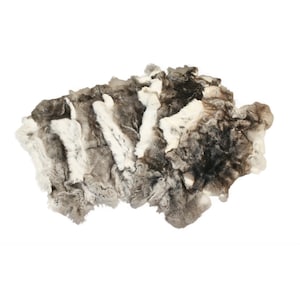 May include: A gray and white rabbit fur throw rug. The fur is soft and fluffy, and the rug is perfect for adding a touch of luxury to any room.