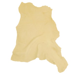 May include: A pale yellow leather hide with a natural, irregular shape.