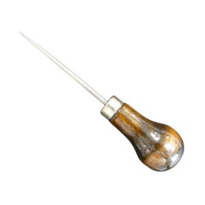 May include: A silver awl with a wooden handle. The awl has a long, pointed tip and a rounded, brown handle with a silver ferrule. The tool is designed for piercing or making holes in materials.