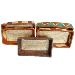 May include: Set of six woven baskets with colorful geometric patterns. The baskets are made of natural materials and have a rustic, handcrafted look.