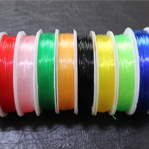 10 spolar med 0,8 mm flerfärgad elastisk nylontråd