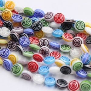 a string of 43 pcs beads millefiori glass flat-round 10,5mm spiral multicolor
