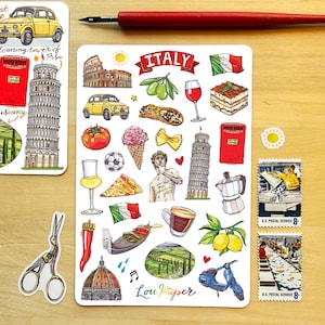 May include: A collection of illustrated stickers featuring Italian landmarks and food, including the Leaning Tower of Pisa, Colosseum, pizza, gelato, and a Vespa scooter. The word "ITALY" is displayed on a banner. Also included are two U.S. Postal Service stamps.