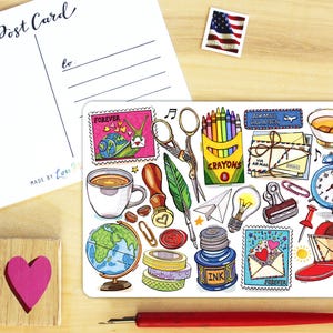 May include: A postcard and a decorative sticker sheet with various stationery-themed illustrations. The sticker sheet includes stamps, scissors, crayons, a teacup, a clock, and a mailbox. A wooden block with a pink heart is also present.